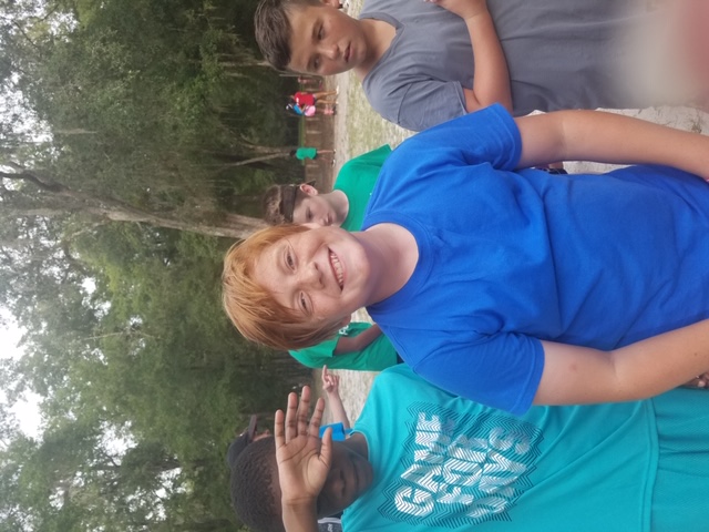 Smiling camper with friends at camp